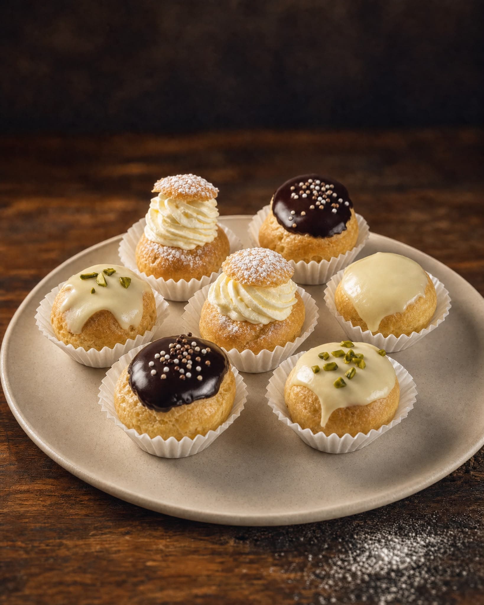Tray of artisan cream puffs and small desserts