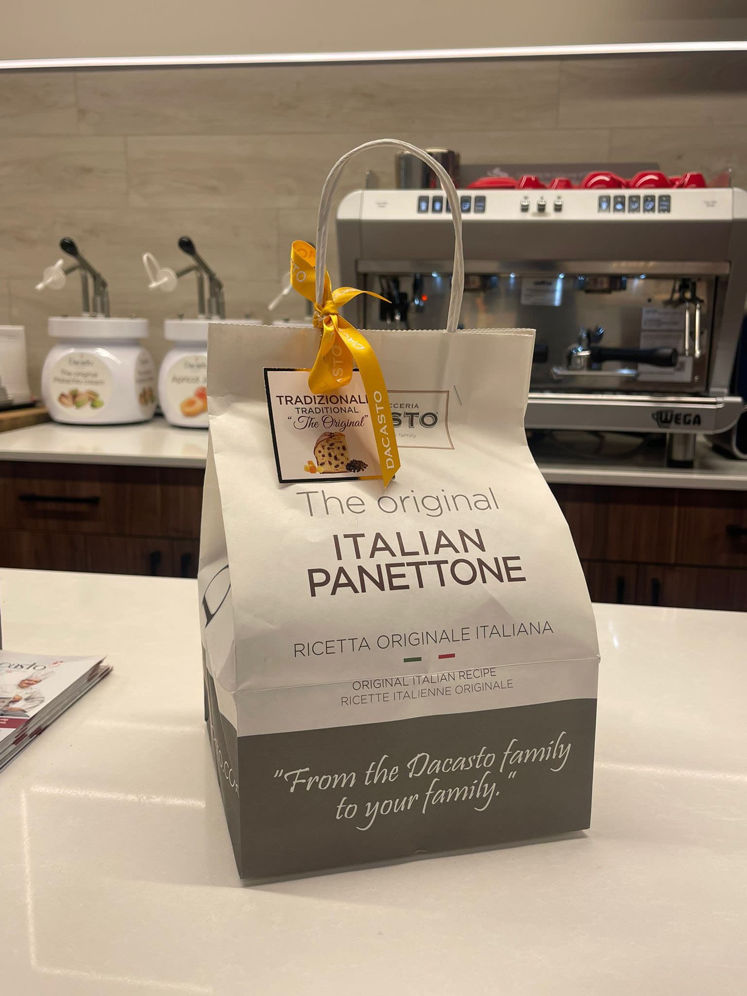 Dacasto panettone gift packaging on a cafe counter
